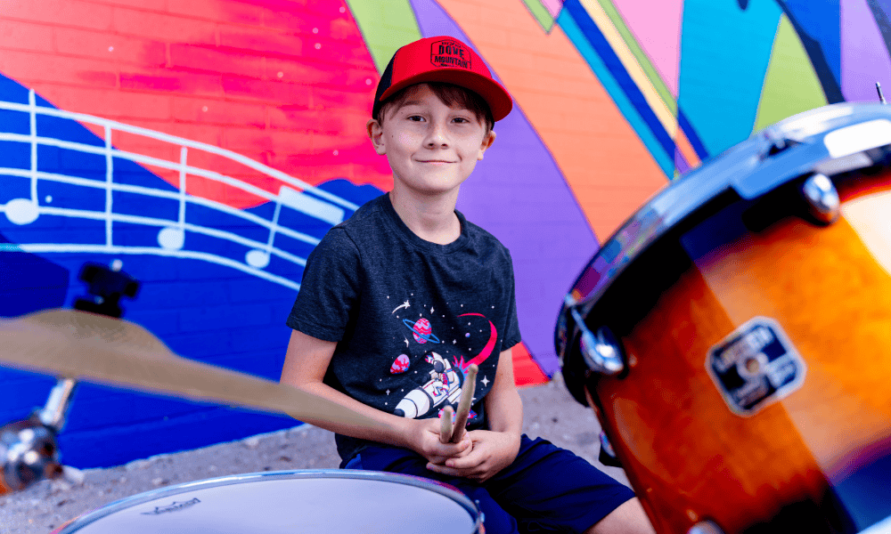 Drum student poses with sticks at Allegro Music and Dance picture day.