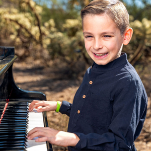 Close-up of hands playing piano keys during lesson at Allegro School of Music and Dance in Tucson.