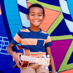Ukulele student smiles with instrument at Allegro Music and Dance in Tucson