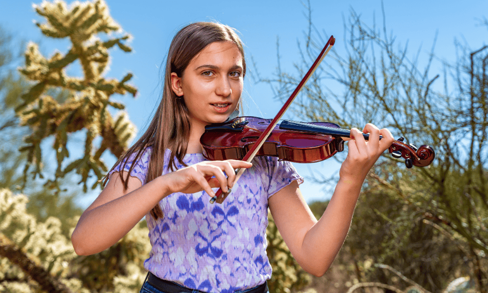 Violin Student from Allegro Music and Dance plays in desert outside of Tucson AZ.