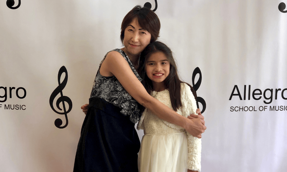 Teacher and student celebrate after Allegro Music and Dance recital.