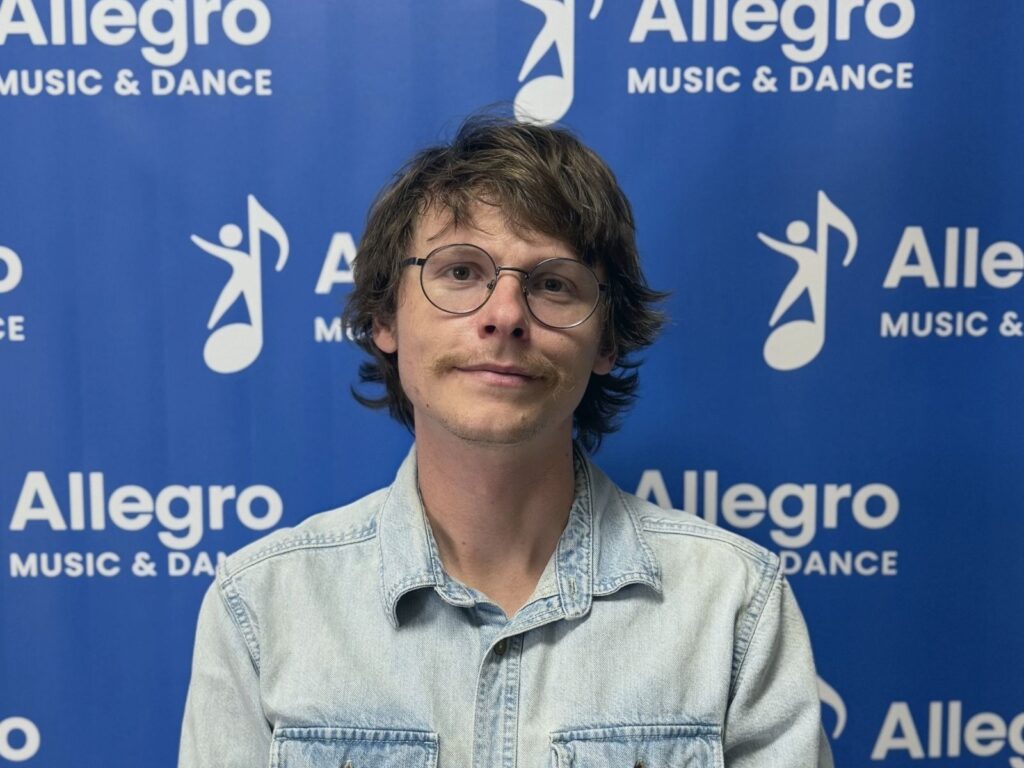 Shua, a guitar, drum, and bass teacher at Allegro Music & Dance in Tucson