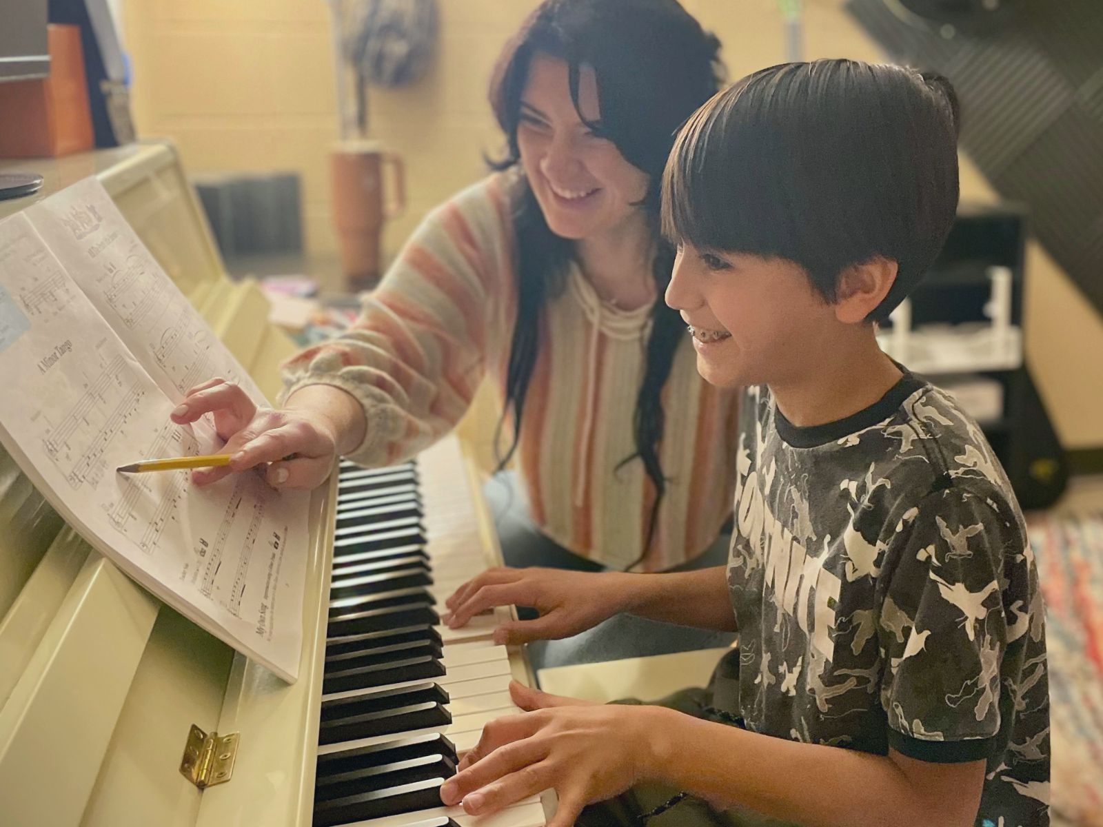 Teacher giving a piano lesson to a student at Allegro Music & Dance in Tucson
