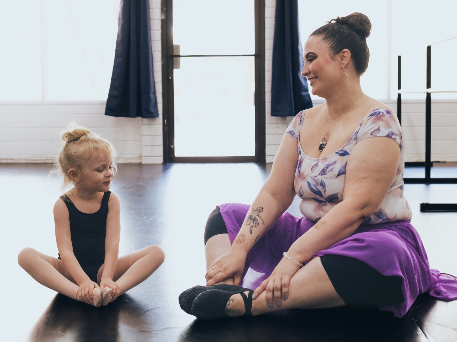 Dance teacher working with a young student in a class at Allegro Music & Dance in Tucson
